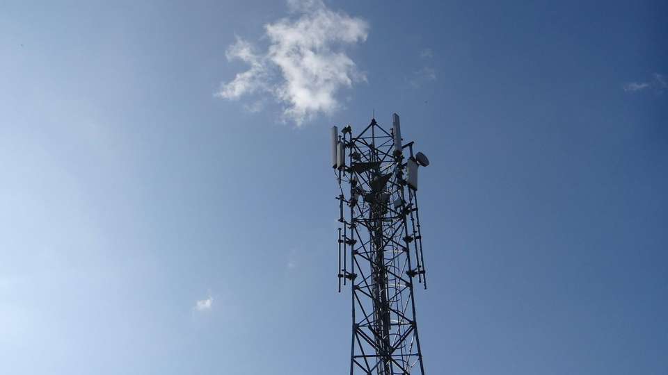 A cellphone tower against a blue sky