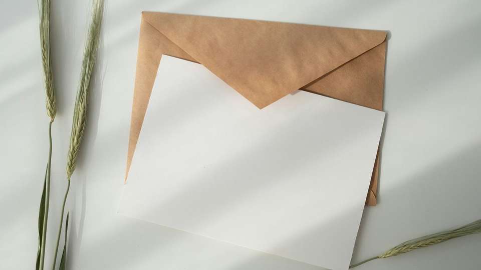 A blank sheet of paper on a brown envelope